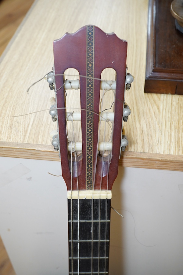 A Suzuki classical guitar, no.3067. Condition - fair, one string missing and scratches to the body.